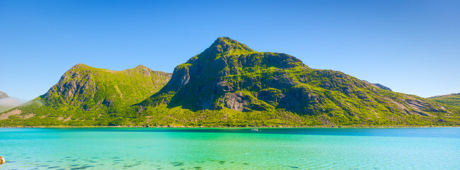 Lofoten islands, Norway. Nordic panoramic scene with transparent water and mountains. Arctic nature. Scenic arctic landscape with blue ocean, majestic peaks and calm summer nature. © biletskiyevgeniy
