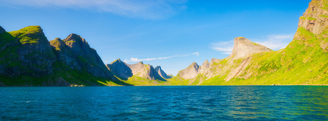 Lofoten islands, Norway. Nordic panoramic scene with mountains. Arctic nature. Scenic arctic landscape with blue ocean, majestic peaks and calm summer nature. Panoramic natural view. © biletskiyevgeniy