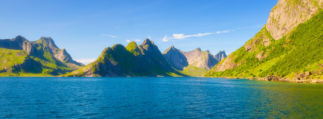 Lofoten islands, Norway. Nordic panoramic scene with mountains. Arctic nature. Scenic arctic landscape with blue ocean, majestic peaks and calm summer nature. Panoramic natural view. © biletskiyevgeniy