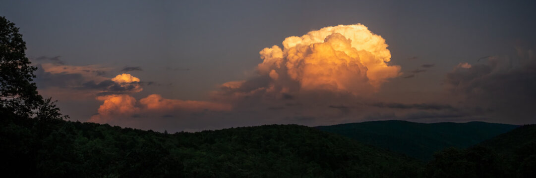Panorama Of Distant Thunder Head Catching The Fading Sun Light