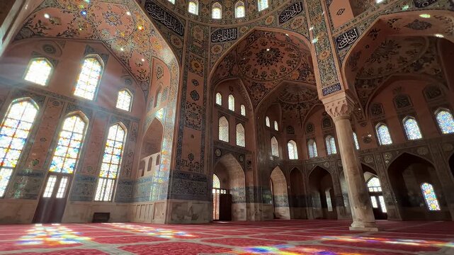 Vibrant Light in Nasir al-Mulk Mosque Prayer Hall - The intricately decorated prayer hall of the Nasir al-Mulk (Pink) Mosque in Shiraz, Iran, showcases stunning architectural details.