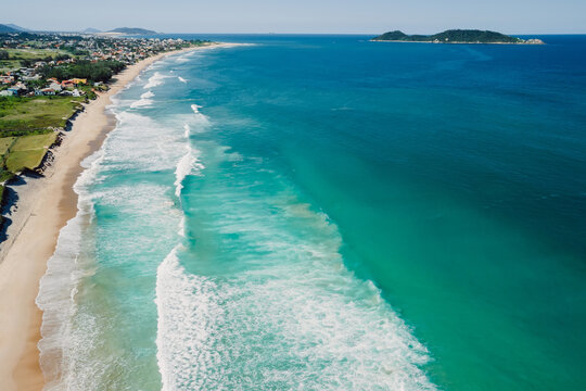 Shoreline and ocean with waves in Brazil. Aerial view of Morro das Pedras beach