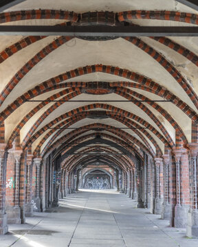 Berlin, Germany - 23 November 2022: View of the vaulted brick walkway of the Oberbaum Bridge with gothic revival arches and decorative ribbing.