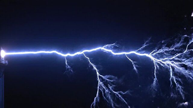 Bright electrical discharge arcing against a dark black background