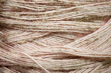 Fototapeta premium Close-up macro texture of soft beige and light pink knitting yarn threads