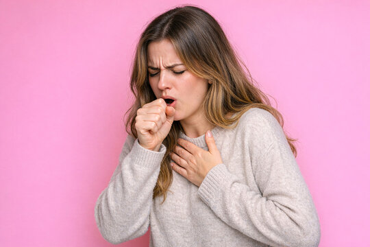The woman is experiencing difficulty breathing and is gasping for air. She appears distressed and has a concerned expression on her face.