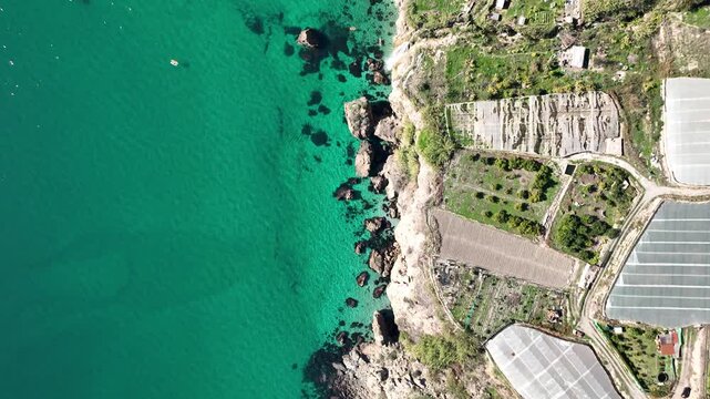 Cinematic Drone Flight Over Turquoise Mediterranean Sea with Cliffs and Waterfall Near Nerja, Andalusia, Spain
