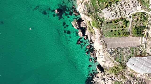 Cinematic Aerial Drone Flight Over Turquoise Mediterranean Sea and Rocky Cliffs Near Nerja, Andalusia, Spain