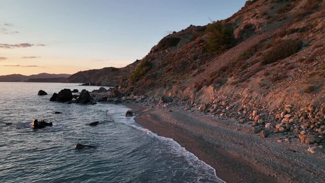 Cinematic Drone Pullback Revealing Secluded Sunset Beach and Rocky Cliffs Near Nerja, Andalusia, Spain