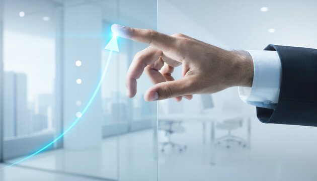 A businessman's hand interacting with a glowing blue upward trending graph projected onto a transparent screen in a modern office environment