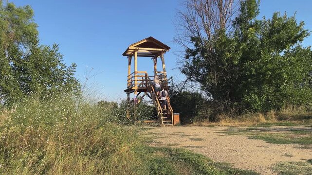 Couple meet lovingly on an observation tower in the park