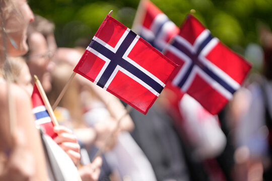 Joyful Crowd Waving Small Norwegian Flags During Patriotic Constitution Day Celebration Parade