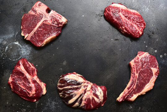 Raw organic marbled beef steaks with ingredients for making.