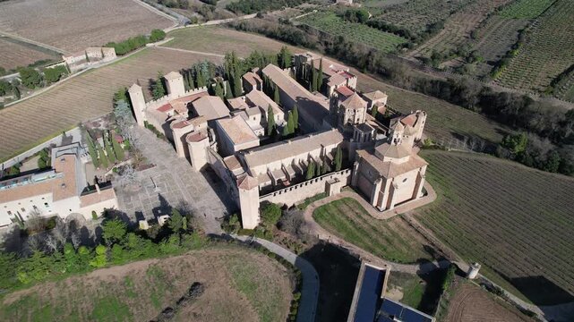 Aerial footage of Santa Maria de Poblet Monastery on sunny winter day. Tarragona Province, Spain.