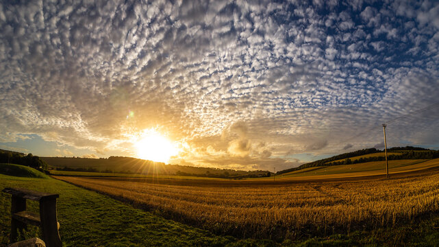 Wide panorama of a glowing sunset over the Meon Valley countryside