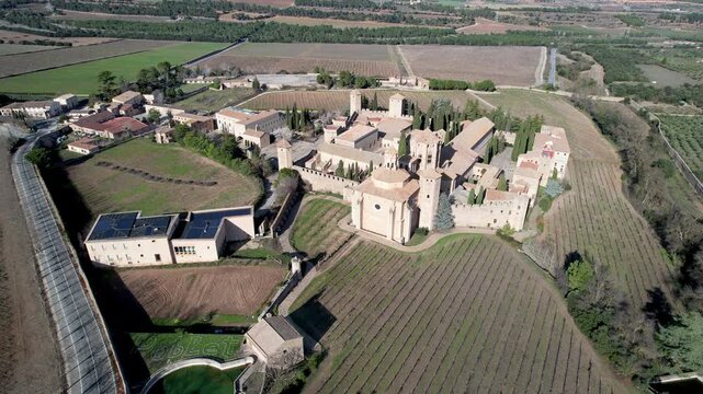 Drone footage shot of Santa Maria de Poblet Monastery on sunny winter day. Tarragona Province, Spain.