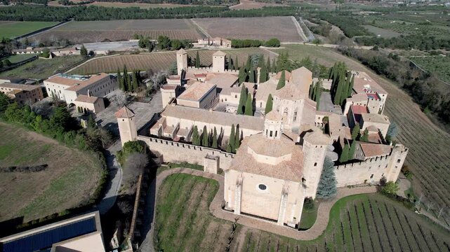 Panoramic aerial shot of Poblet Monastery on sunny winter day. Tarragona Province, Spain.
