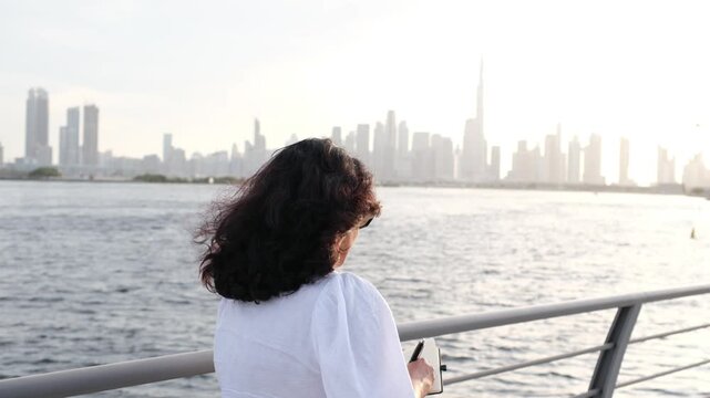 Journaling woman by waterfront at sunset with self reflection and productivity concept