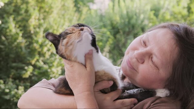 plus size woman holding calico cat, tortoiseshell feline, hugging pet and care, Human animal bonding friendship, furry friend, animal lover, casual clothing, domestic kitten, warmth and trust