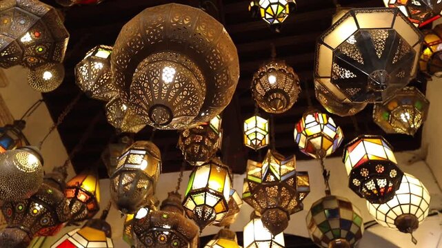 Various traditional moroccan lamps on the ceiling at the entrance of moroccan riyad house in Rabat