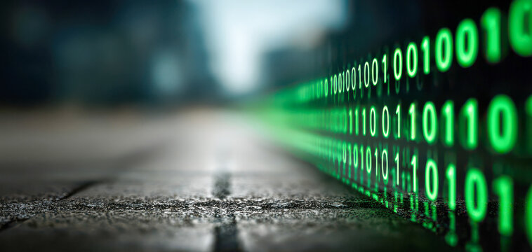 Digital data flows across the ground during a night scene in an urban area using green binary code symbols for effect