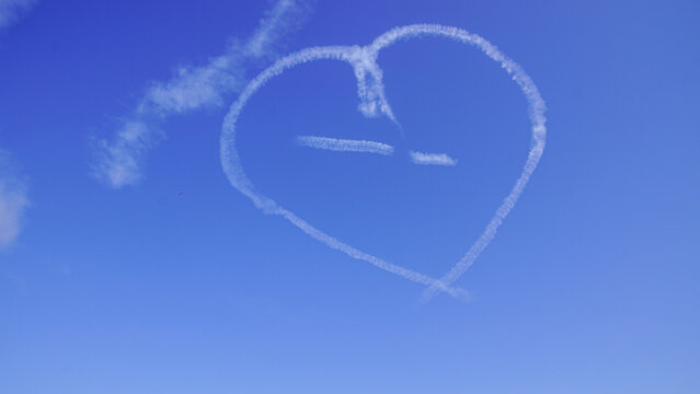 Heart Shaped Skywriting Cloud Against a Clear Blue Sky