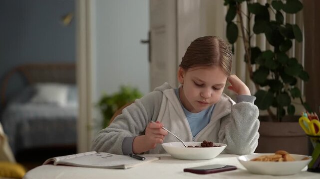 White girl at breakfast table studying bowl of cereal, notebook and pen under soft morning light, cozy kitchen background, elementary student concentrating .