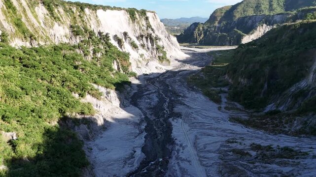 Cinematic Drone Shot of the Rugged Volcanic Canyon and Winding Riverbed at Mount Pinatubo, Philippines