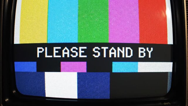 Retro TV screen displays 'Please Stand By' color test pattern