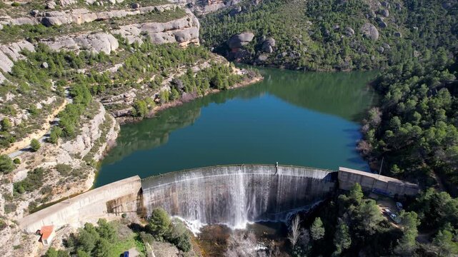 Tripod aerial shot of Margalef dam on sunny winter day. Tarragona Province, Spain.