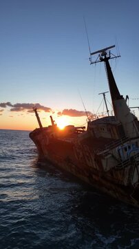 Aerial view of the Edro III shipwreck in Paphos at sunset with waves crashing(Vertical 4K 9:16)