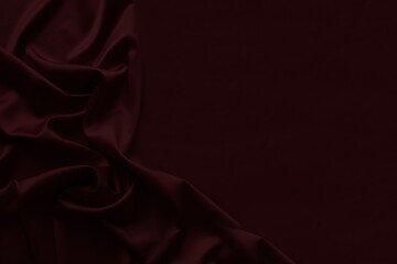 Naklejka premium Black dark burgundy red silk fabric with elegant drapery folds, luxury satin textile background, rich crimson velvet style abstract backdrop. Festive. Empty template design ad.Top view table, flat lay