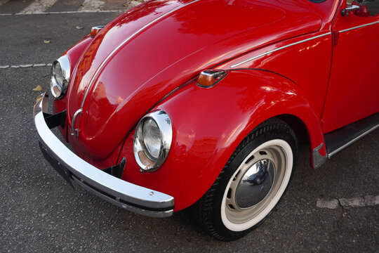 Classic Red Volkswagen Beetle Featuring Timeless Rounded Design and Polished Chrome Hubcaps