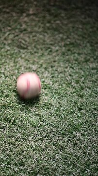 Baseball , selective focus vertical video of a baseball , grass moving ball bokeh background video
