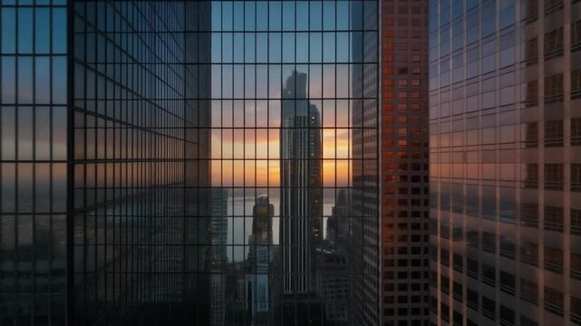 Kuwait City skyline reflection on modern glass skyscraper at sunset
