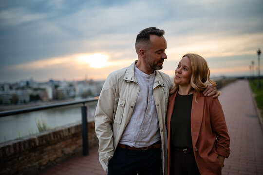 Adult couple enjoying sunset city view together