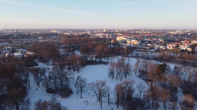Aerial View of a Snow Covered Urban Park During a Peaceful Winter Sunset in Leipzig, Germany