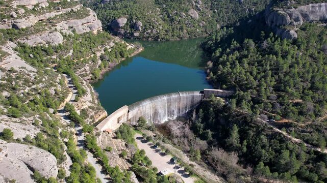 Forward reveal aerial shot of Margalef reservoir and dam. Tarragona Province, Spain.