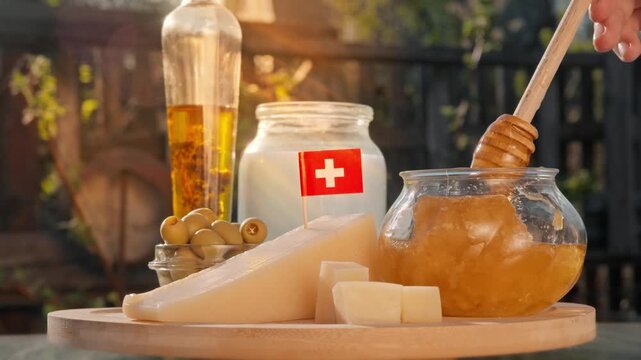 Swiss honey pours from honey dipper near local cheese and dairy items in a sunlit countryside food composition that feels handcrafted and authentic.