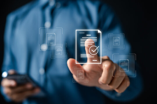 Document verification and business paperwork approval. Man pointing at document checkmark using smartphone for compliance quality standard management and data auditing.