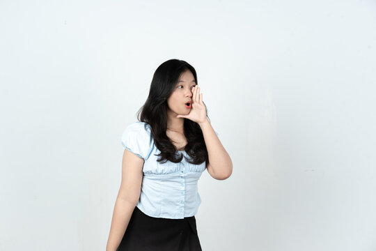Young Asian woman whispering or shouting news from side view in studio
