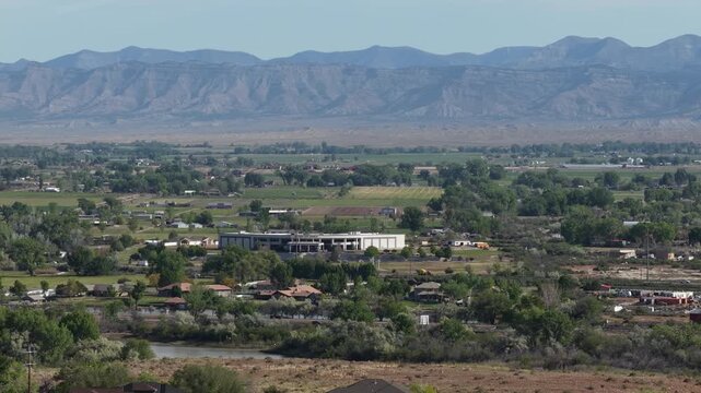 Aerial of church and rural Redlands neighborhood in Grand Junction Colorado in spring with Book Cliffs view