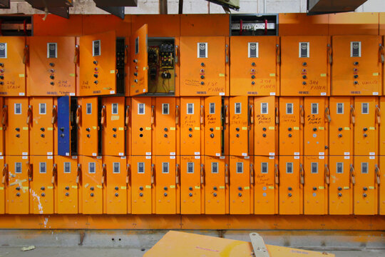 Rows of Orange Allen-Bradley Industrial Electrical Control Panels in Abandoned Factory