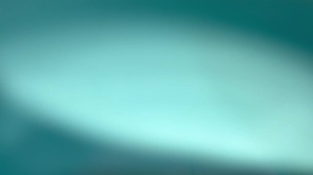 Abstract blurred turquoise blue gradient background with soft light