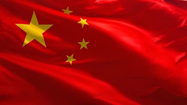 A bright red fabric flag with five yellow stars waving in the wind