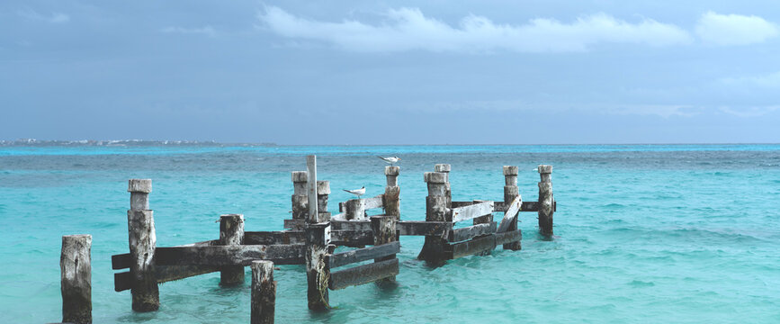 Remains of an old pier on Playa Caracol beach in Cancun, Mexico