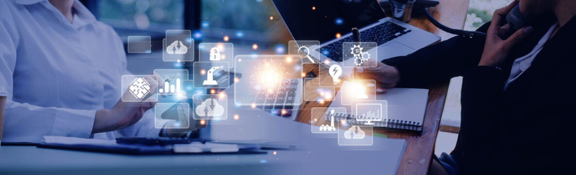 Professionals collaborating at a modern workspace with digital technology icons overlay representing business innovation and connectivity