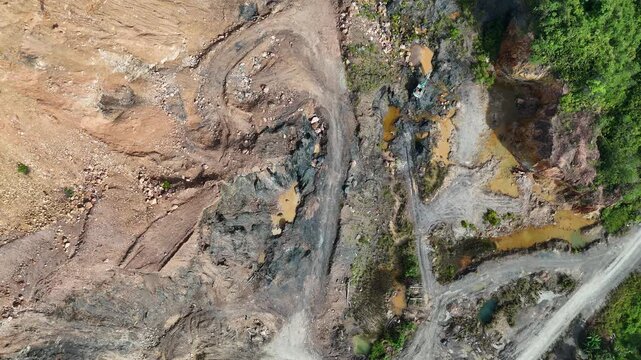 aerial view of a landslide or mudslide area with road and trees.