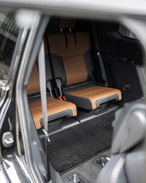 Rear Passenger Seats Inside Car with Brown Upholstery Interior.