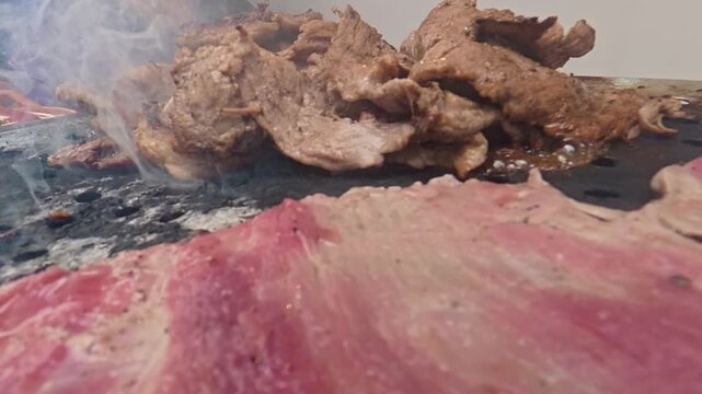 Mexican carne asada grilling on comal